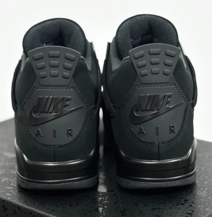 Air Jordan All-Black Sneakers with Grid Panels and Glossy Lace Tabs